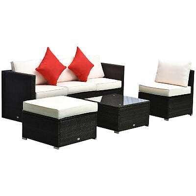 A white and black furniture with red pillows.