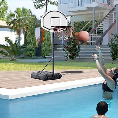 A woman playing basketball in a pool with a basketball hoop.
