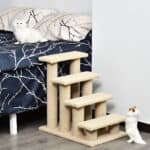 A bed with a cat on top of it.