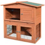 A wooden rabbit hutch with a roof.