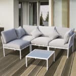 A white patio furniture set on a wooden deck.