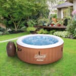 A hot tub in a yard.