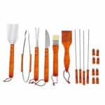 A set of orange bbq tools on a white background.