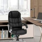 A black leather office chair in front of a desk.