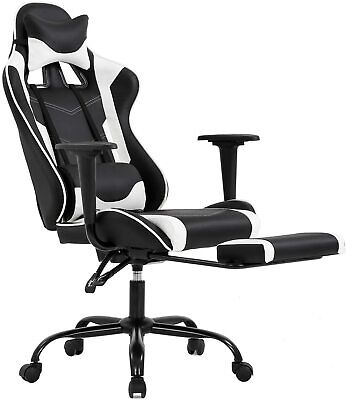 A black and white gaming chair with a footrest.