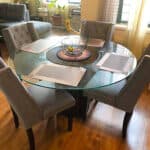 A glass dining table in a living room.