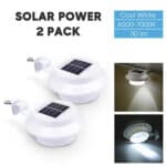 Two solar powered lights on a white background.