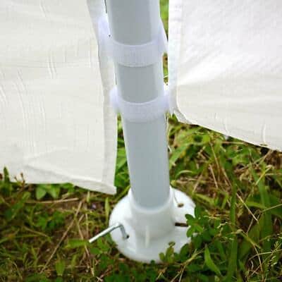 A white pole with a white tent attached to it.