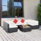 Outdoor patio setting with a modular wicker sectional sofa and a matching coffee table.