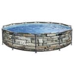 Above-ground swimming pool with a faux stone exterior design.