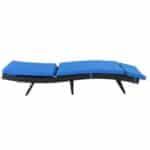 Outdoor wicker chaise lounge with blue cushions.