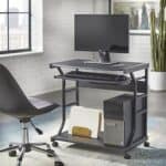 Compact office workstation with a desktop computer, keyboard tray, and storage shelves.