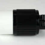 Black and white cylindrical object, possibly an adapter or connector, with a ridged surface and a rotating element on a grey background.