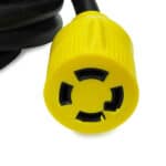 Yellow and black three-pronged twist-lock electrical plug.