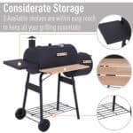 Black barbecue grill with additional shelves highlighted to emphasize convenient storage features.