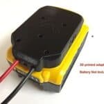 3d printed black and yellow battery adapter connected to a red and black wire on a white background, labeled "3d printed adapter only, battery not included.