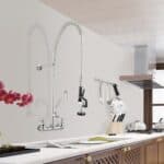 A kitchen with a stainless steel sink and faucet.