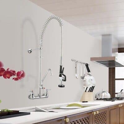 A kitchen with a stainless steel sink and faucet.