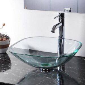 A bathroom sink with a glass bowl on top of a black counter.