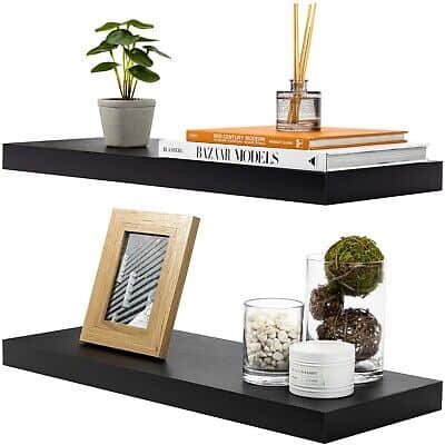 Two black floating shelves with plants on them.