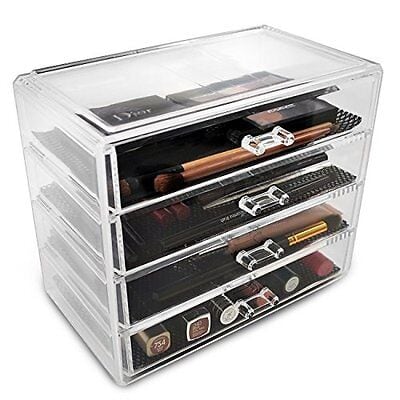 A clear acrylic makeup storage box with several drawers.