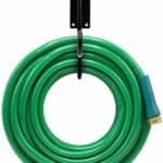 A green hose hanging on a hook.