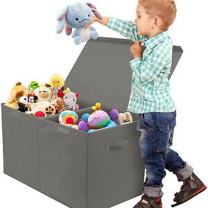 A child is playing with stuffed animals in a storage box.