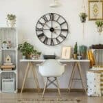 A room with a white desk and a clock.