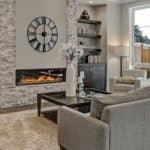 A living room with a fireplace and a clock.