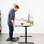 A man standing in front of a desk.