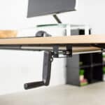 A desk with a monitor attached to it.