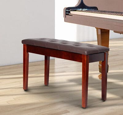 A piano bench in front of a piano.