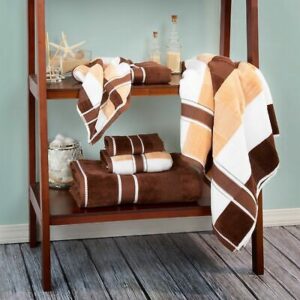 A shelf with brown and white towels on it.