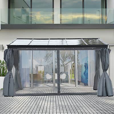 A patio gazebo with curtains on a patio.