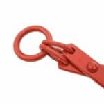 A red metal hook on a white background.