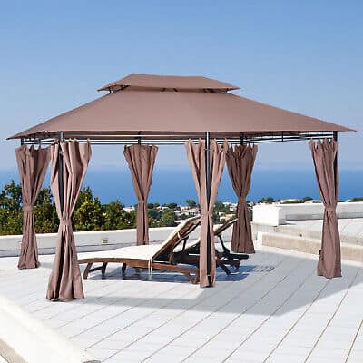 A brown gazebo on a patio with a view of the ocean.