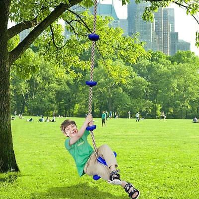 A boy swinging on a swing in a park.