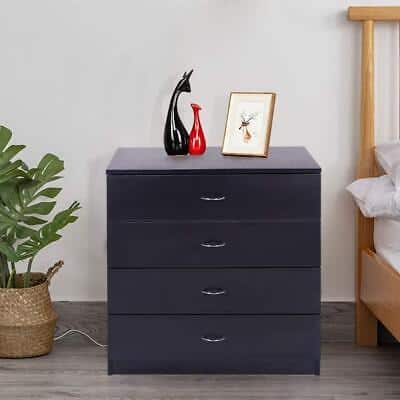 A black chest of drawers in a bedroom.