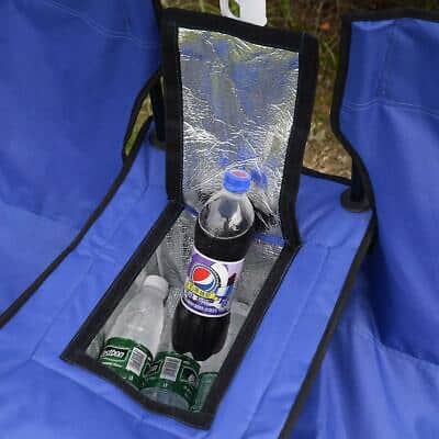 A blue folding chair with a bottle of water in it.