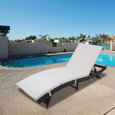 A white chaise lounge next to a pool.