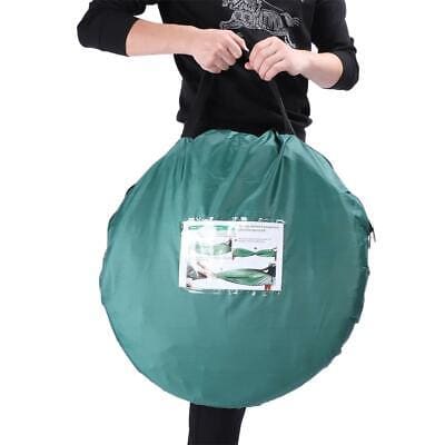 A woman is holding a green bag.