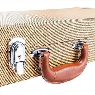 A tan suitcase with a leather handle on a white background.
