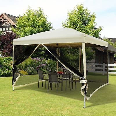 A gazebo with a table and chairs in the yard.