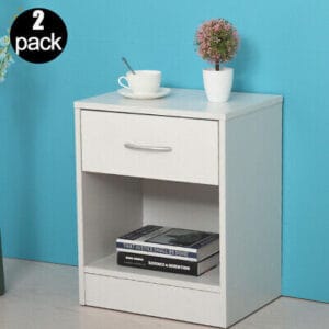 A white nightstand with two drawers and a book.