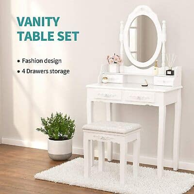 A white vanity table with a mirror and stool.
