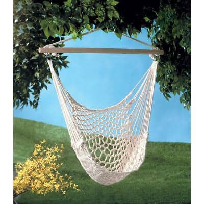 A white hammock hanging from a tree.