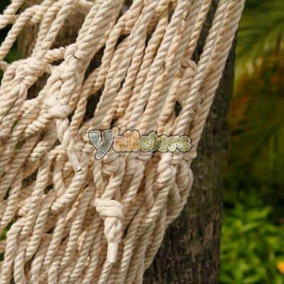 A rope hammock hanging from a tree.