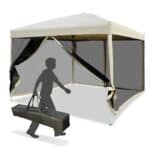 A person carrying a bag under a gazebo.