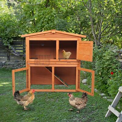 A wooden chicken coop with two chickens in it.