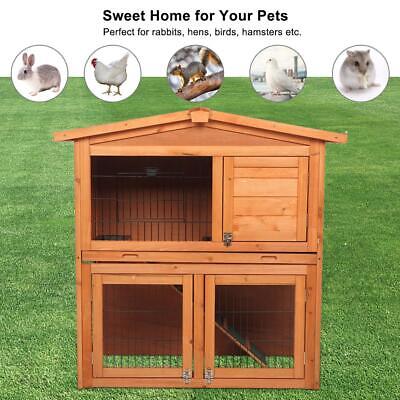 A wooden rabbit hutch with a picture of a bunny.